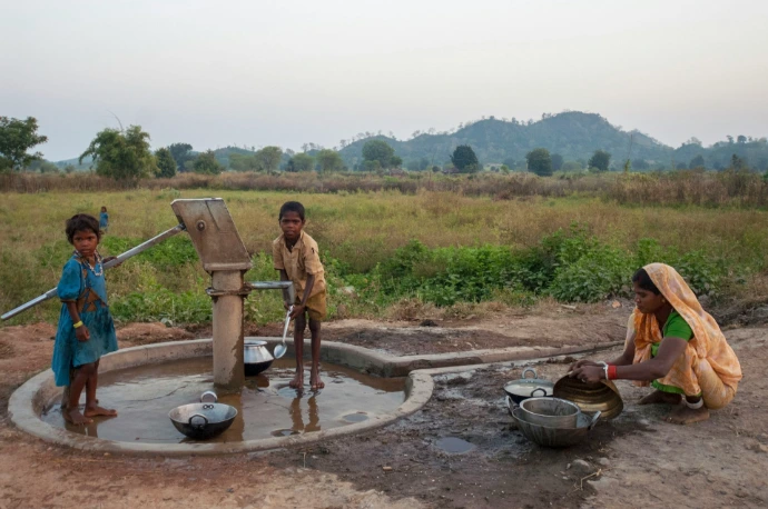 People draw water from a well in a rural area